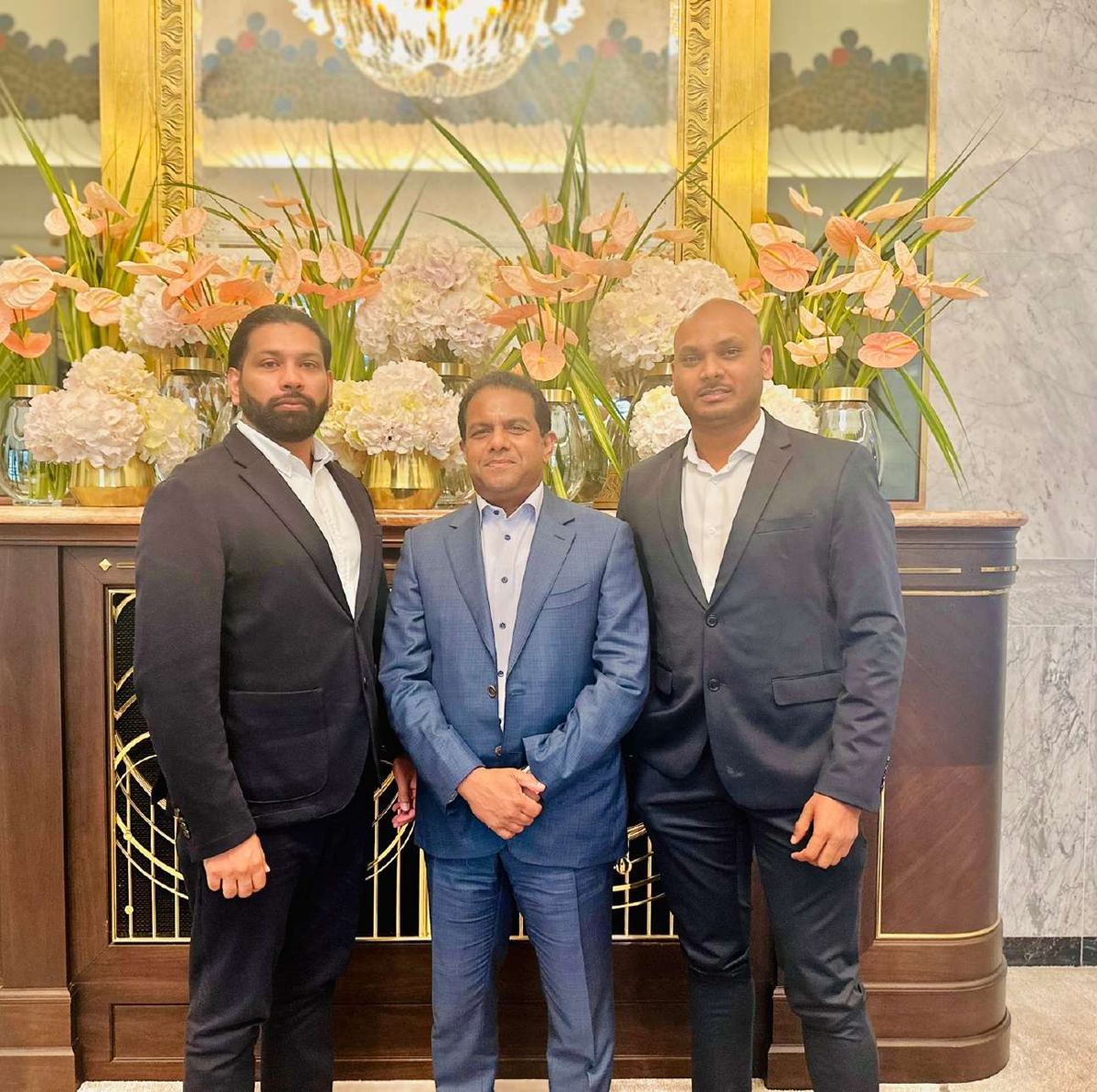 Muneer Shaikh with business partners at a hotel reception